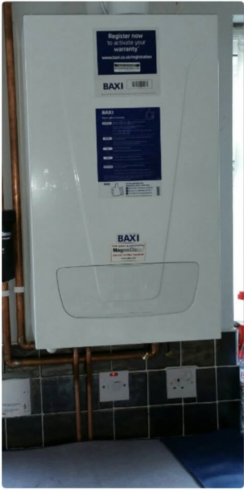 A new Baxi boiler fitted in a kitchen with tidy copper pipework