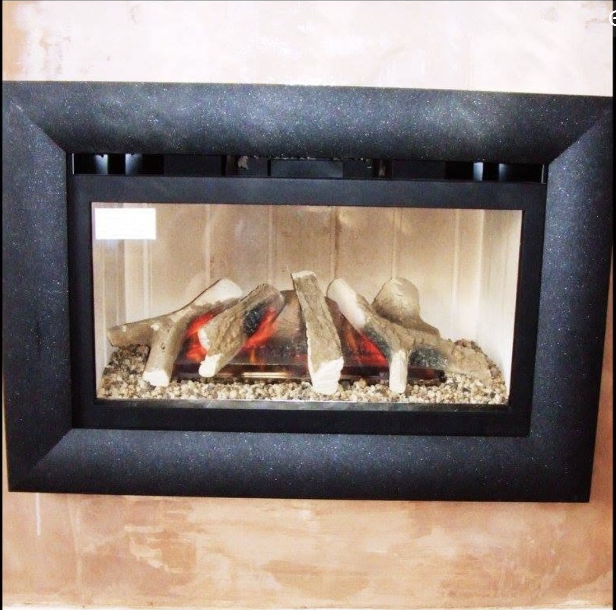 A gas fire installation in progress, with the old fire removed and the new fire fitted
