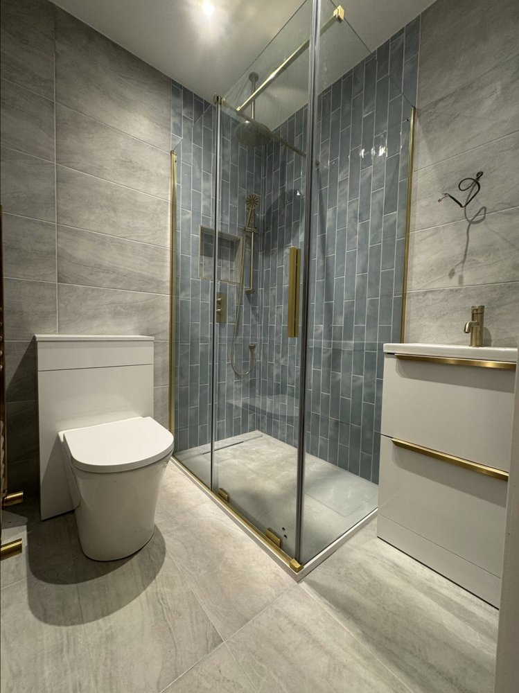 Shower room with blue vertical tiles and brushed gold shower frame