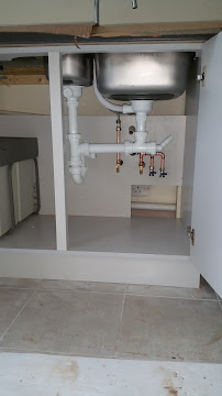 Neat new plumbing under a kitchen sink